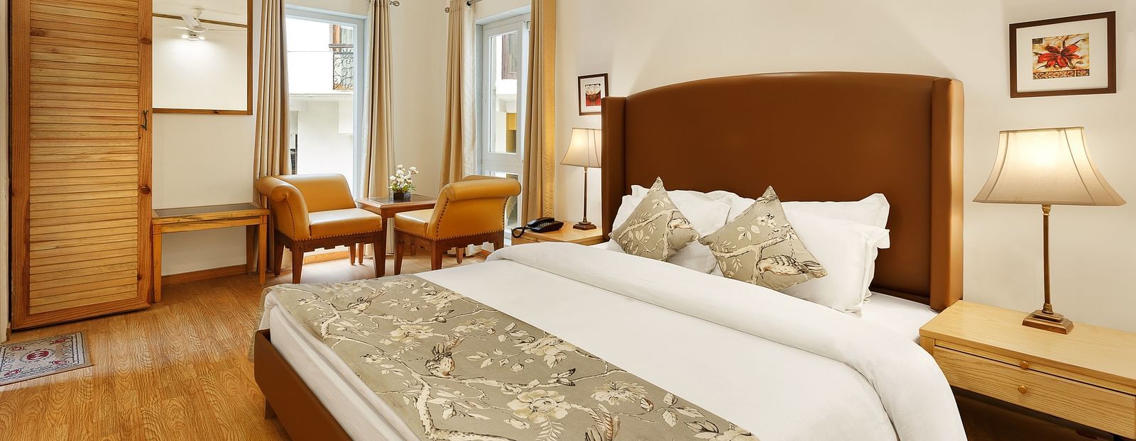 A cosy room with comfortable bed a seating area with sofa and chairs and a table lamp, Pinewood Nainital