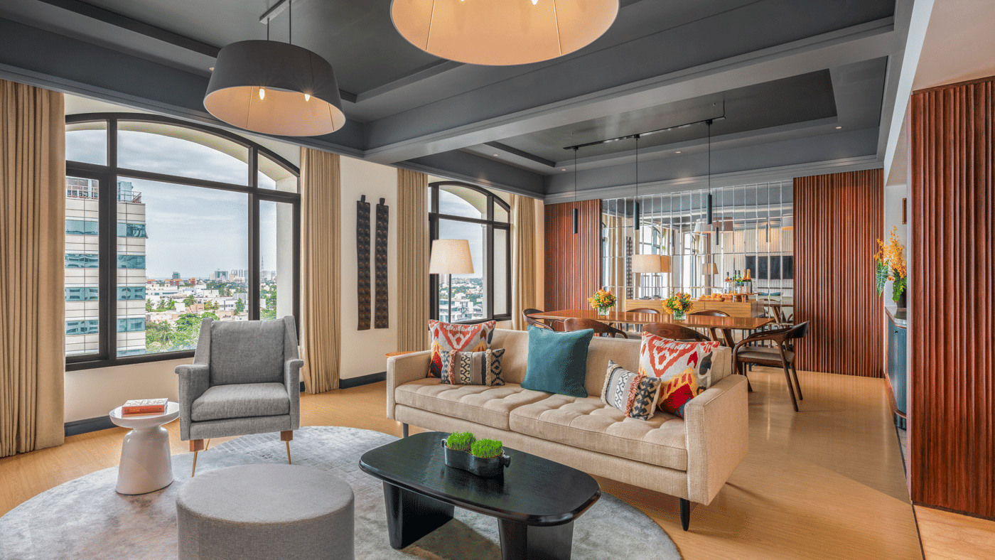 Lounge with sofas, chairs, and large windows at The Raintree, St. Mary’s Road.