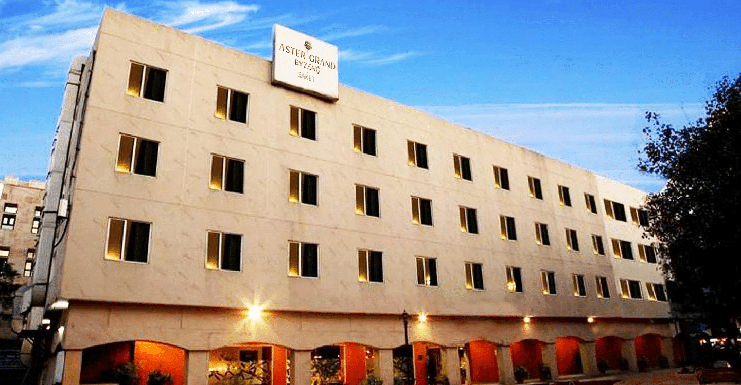 Street view of ZENQ Hotels & Resorts showcasing its modern exterior and welcoming entrance in an urban setting.