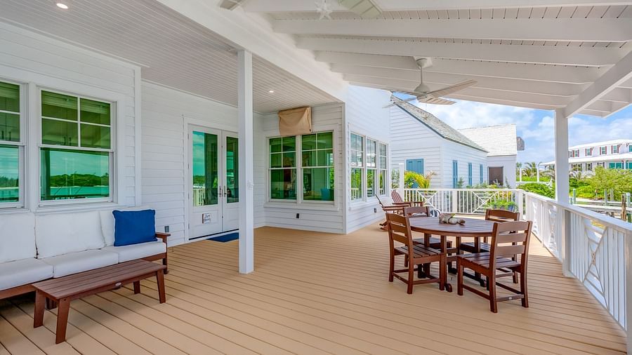 Covered outdoor dining area on a wooden deck overlooking the waterfront | Abaco Inn