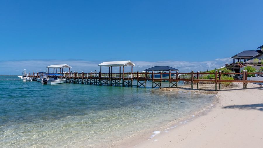 Shoreline with villas and docked boats across the bay | Abaco Inn
