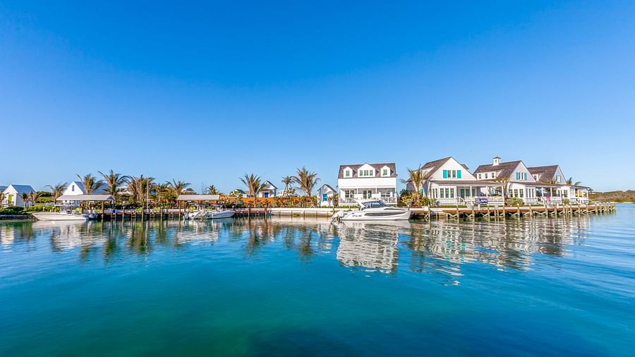 Calm water with villas and palm trees on the opposite side | Abaco Inn