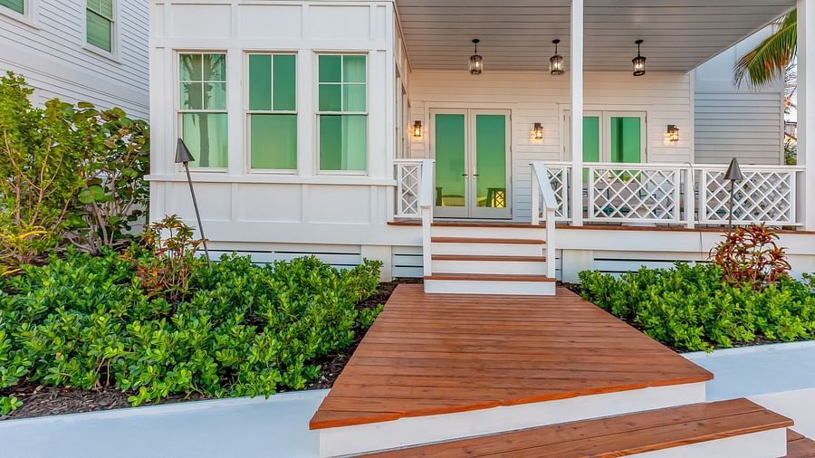 Facade of Abaco Inn with wooden dock and greenery.
