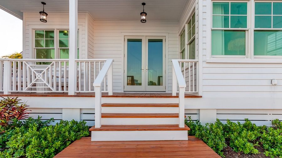 Facade of Abaco Inn with wooden dock and potted plants. 
