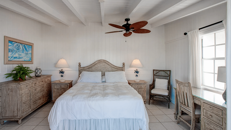 Bedroom with a double bed, ceiling fan, and natural light | Abaco Inn