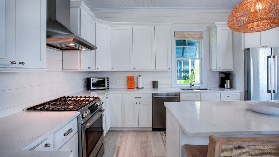 Kitchen with stainless steel appliances and a wooden dining table | Abaco Inn