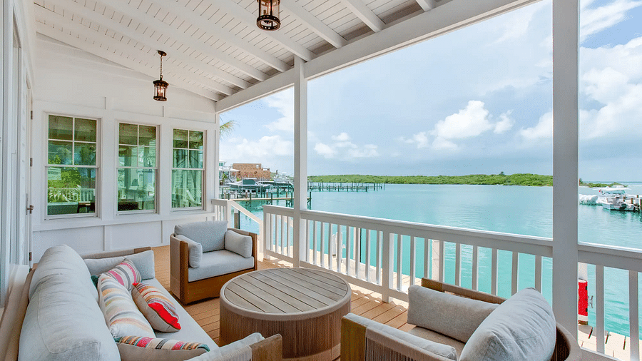 Outdoor seating area on a covered deck overlooking the water | Abaco Inn