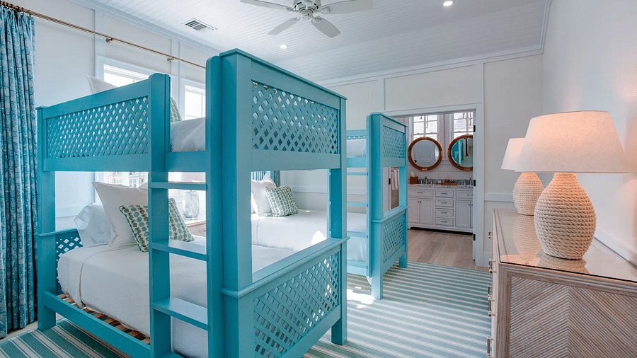 Bedroom with blue four-poster beds and striped carpet | Abaco Inn