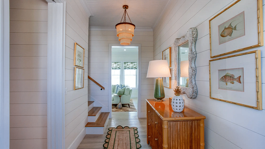 Hallway with wooden console table, framed artwork, and coastal decor | Abaco Inn