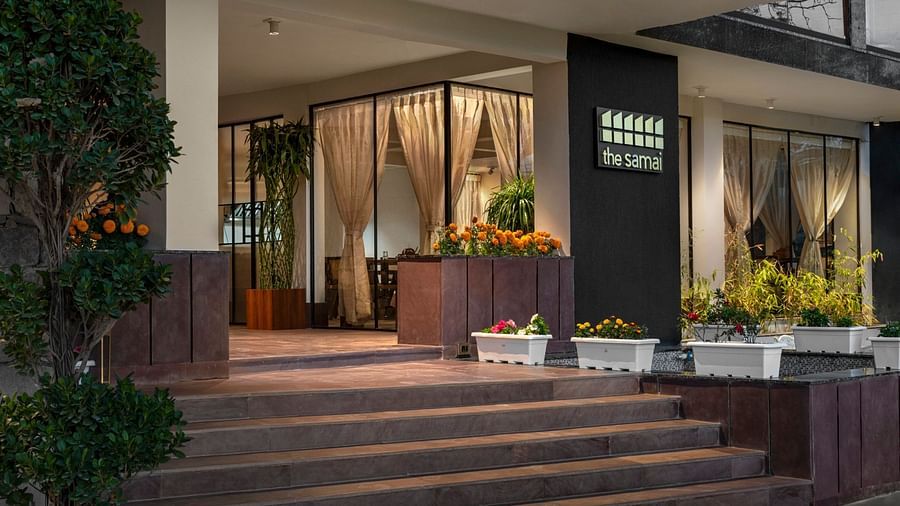 A facade image of the hotel with a sign board stating the name of the hotel - The Samai, Bhimtal