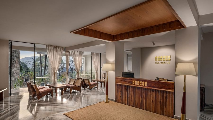 A reception area with a reception desk and comfortable furniture to sit and relax - The Samai, Bhimtal