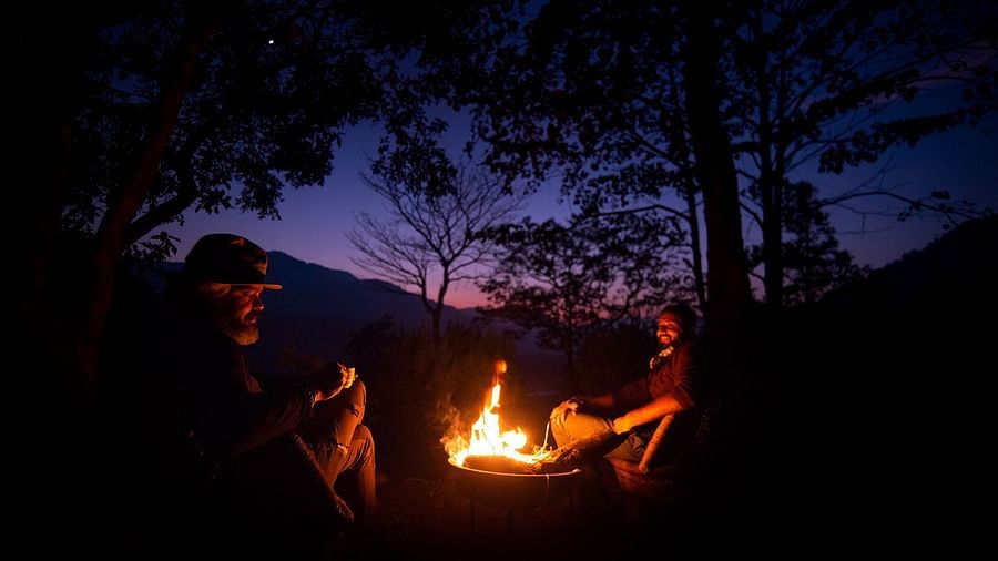 people sitting around a bonfire in the evening - The Jamoon, Corbett