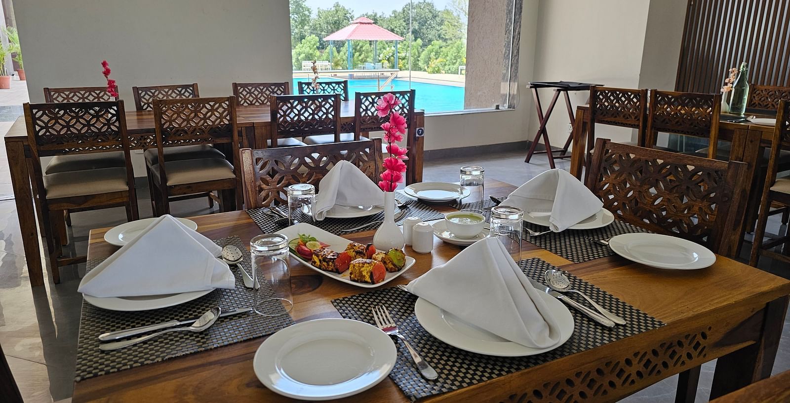 A dining table is laden with various food items and cutlery - Bamboo Saa Mulberry Resort, Pushkar