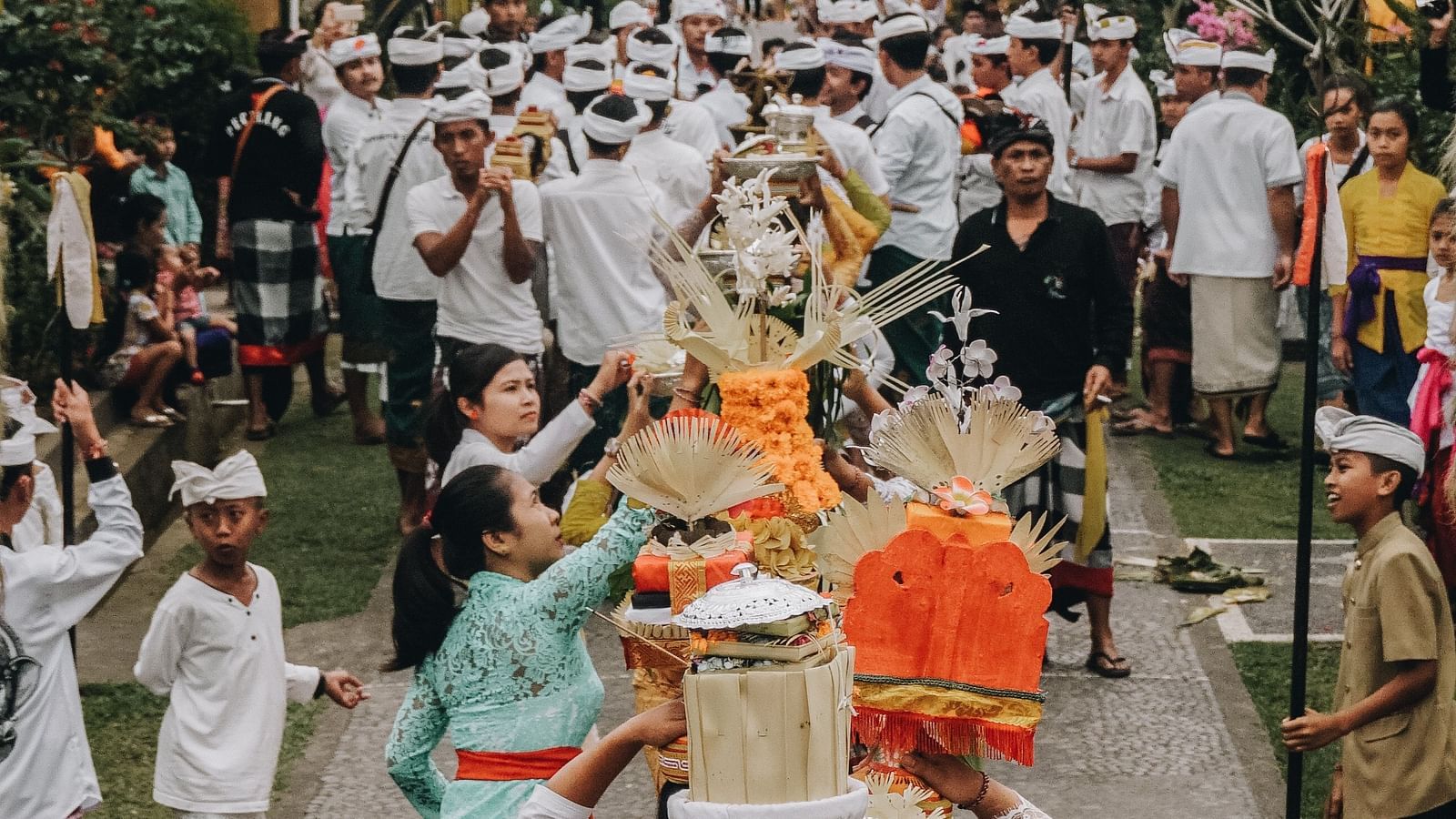 a celebration procession on the road with a mob in Bali
