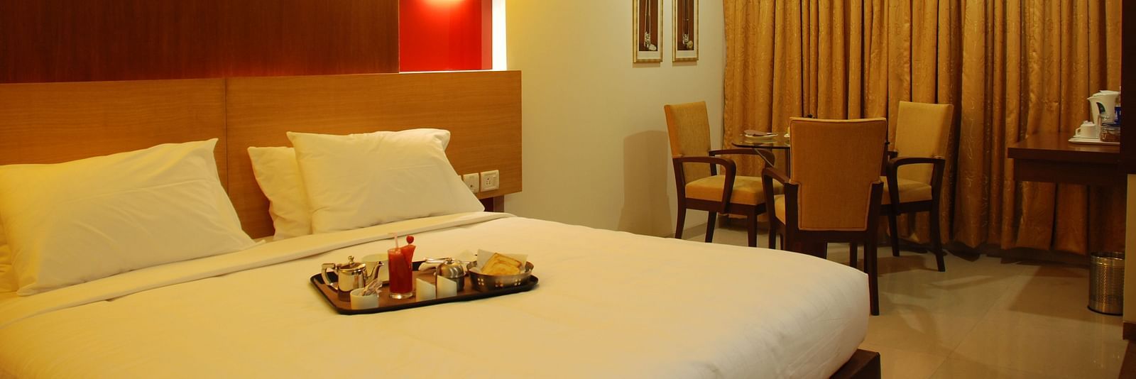 Luxury room with bed and seating area and bed at The Oriental Residency 