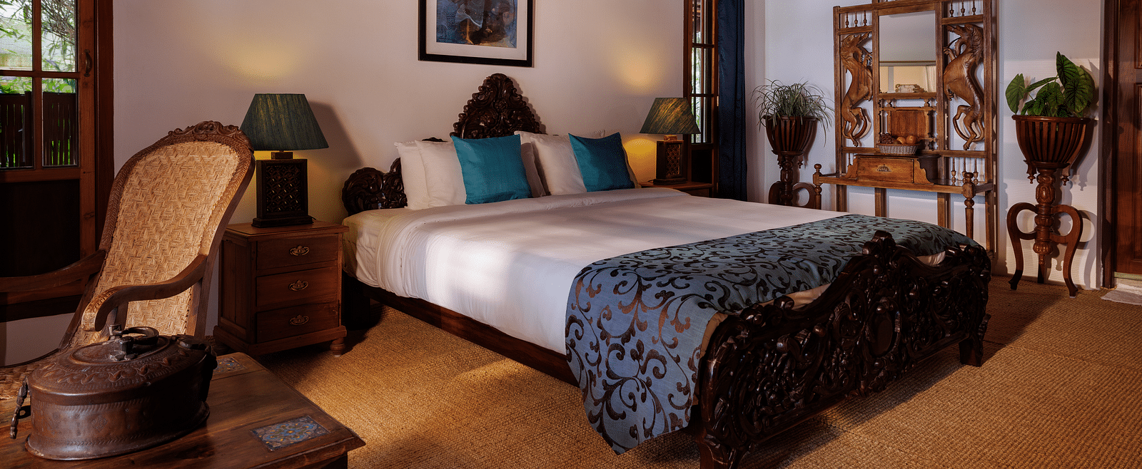 A room with a bed, a wooden dresser, a chair, and a coffee table - BluSalzz Villas - Muhamma Resort, Alleppey