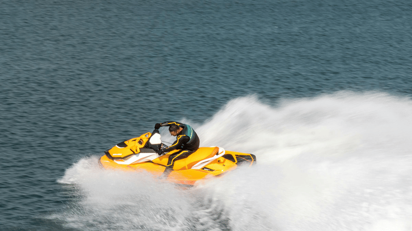 A person riding a jet ski on a clear, blue day