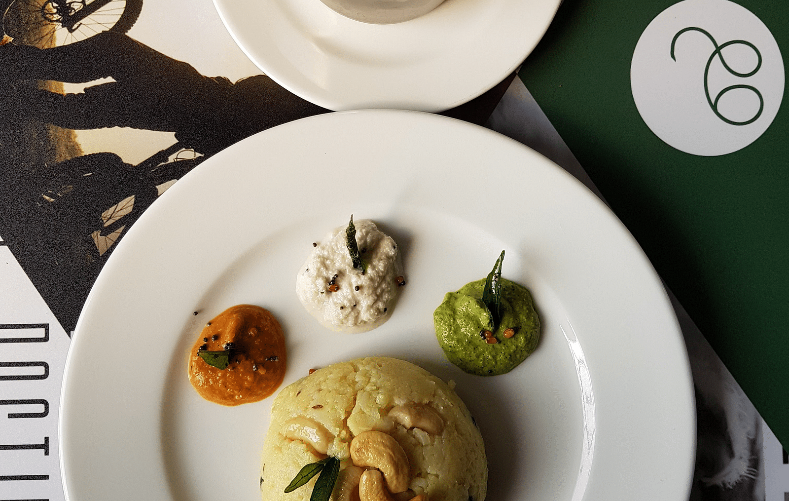 A plate with south Indian delicacies and various sauces placed on a table  