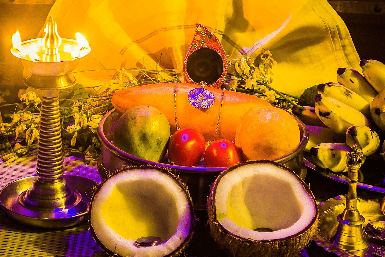 An overview of Vishu Kanni in Kerala with an idol of Krishna placed in front of food items.