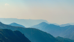 an overview of the mountains in Shillong with blue sky in the background