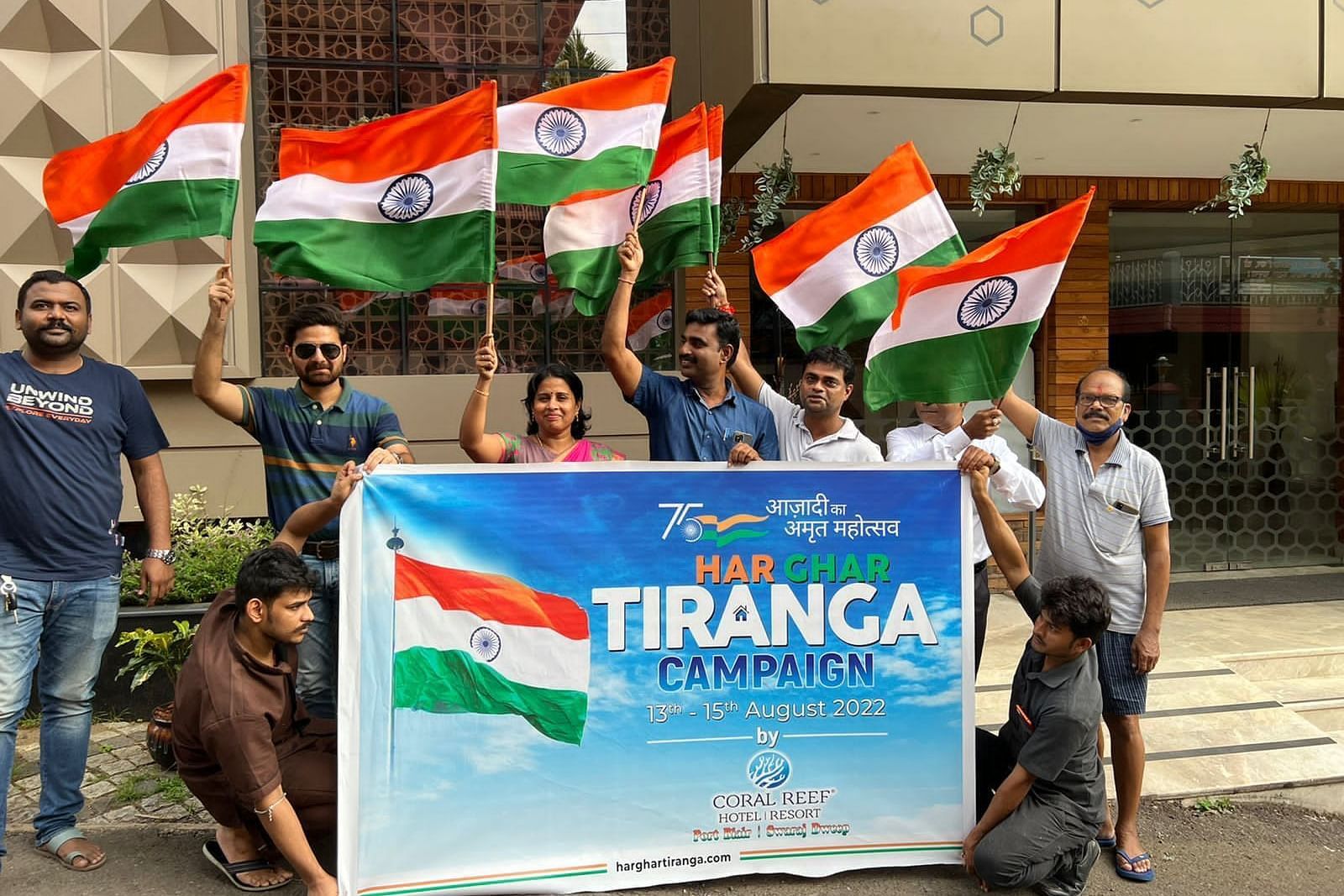 Group of men holding a banner and Indian Flag at Coral Reef Hotel & Resort