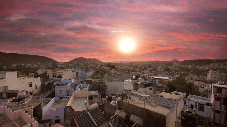 An aerial view of the Sanmukh city  with a serene pink sky during a sunset.