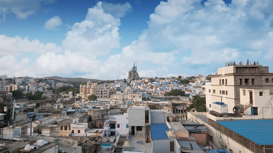 An aerial view of the sanmukh city with a cloudy clear blue sky .