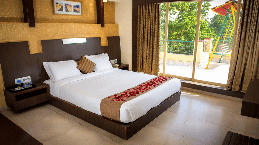 The bedroom of the Adamo's Royal room with a view of the balcony with a swing.