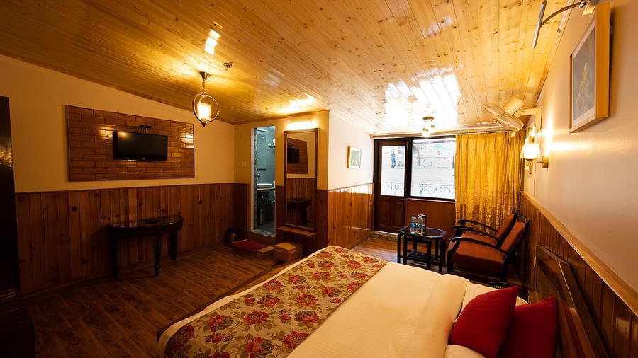 Side view of the Balcony room with a cozy bed and stylish interior design at The Pavilion, Nainital