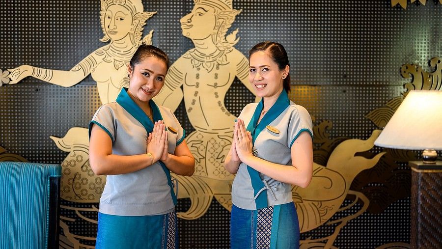 image of two staff members posing for a picture with their hands joined to greet the guests - Maikhao Dream Villa Resort & Spa, Phuket