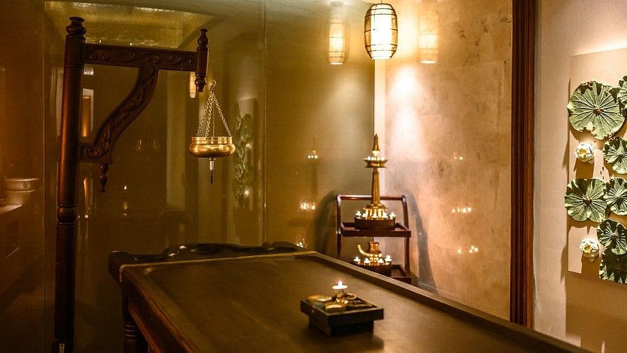 image of a wooden bed in the middle of the room with dim warm lighting at maikhao dream spa