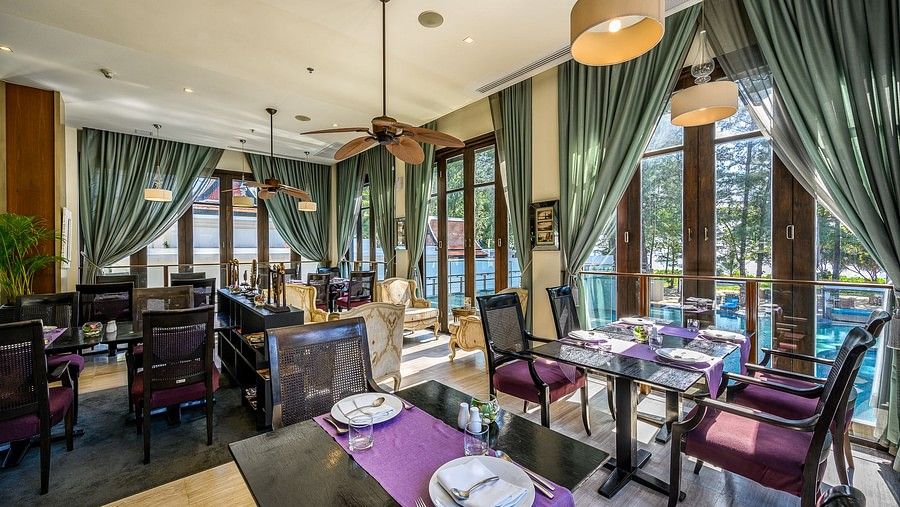 image of the indoor restaurant with chic interiors overlooking the swimming pool from the windows - Maikhao Dream Villa Resort & Spa, Phuket