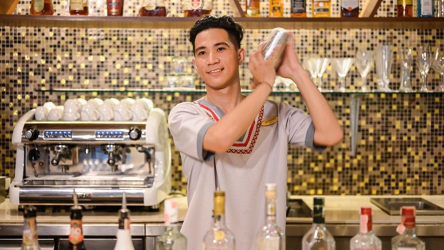 image of a professional bartender making cocktails behind the counter - Maikhao Dream Villa Resort & Spa, Phuket