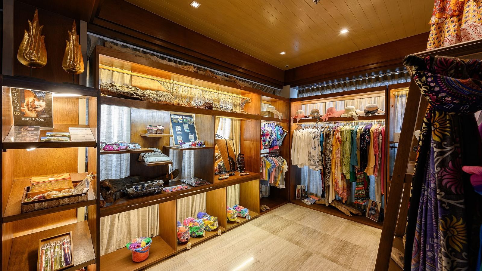 The corner view of the souvenir shop with a lot of clothes hanging - Maikhao Dream Villa Resort & Spa, Phuket