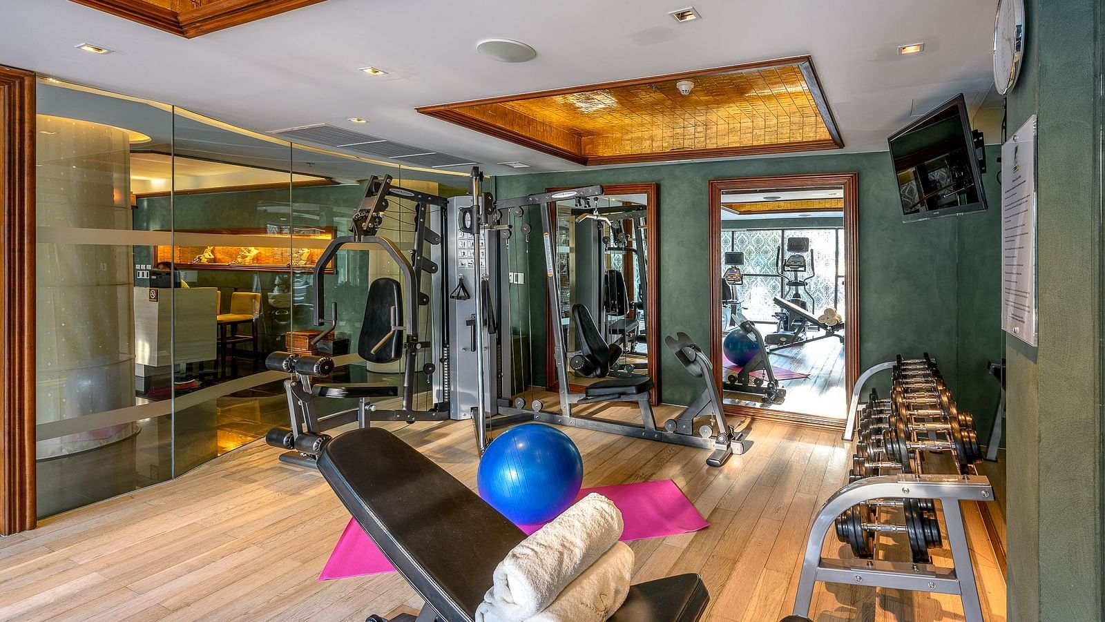 corner view of the fitness centre with a pink yoga mat in the centre of the room - Maikhao Dream Villa Resort & Spa, Phuket
