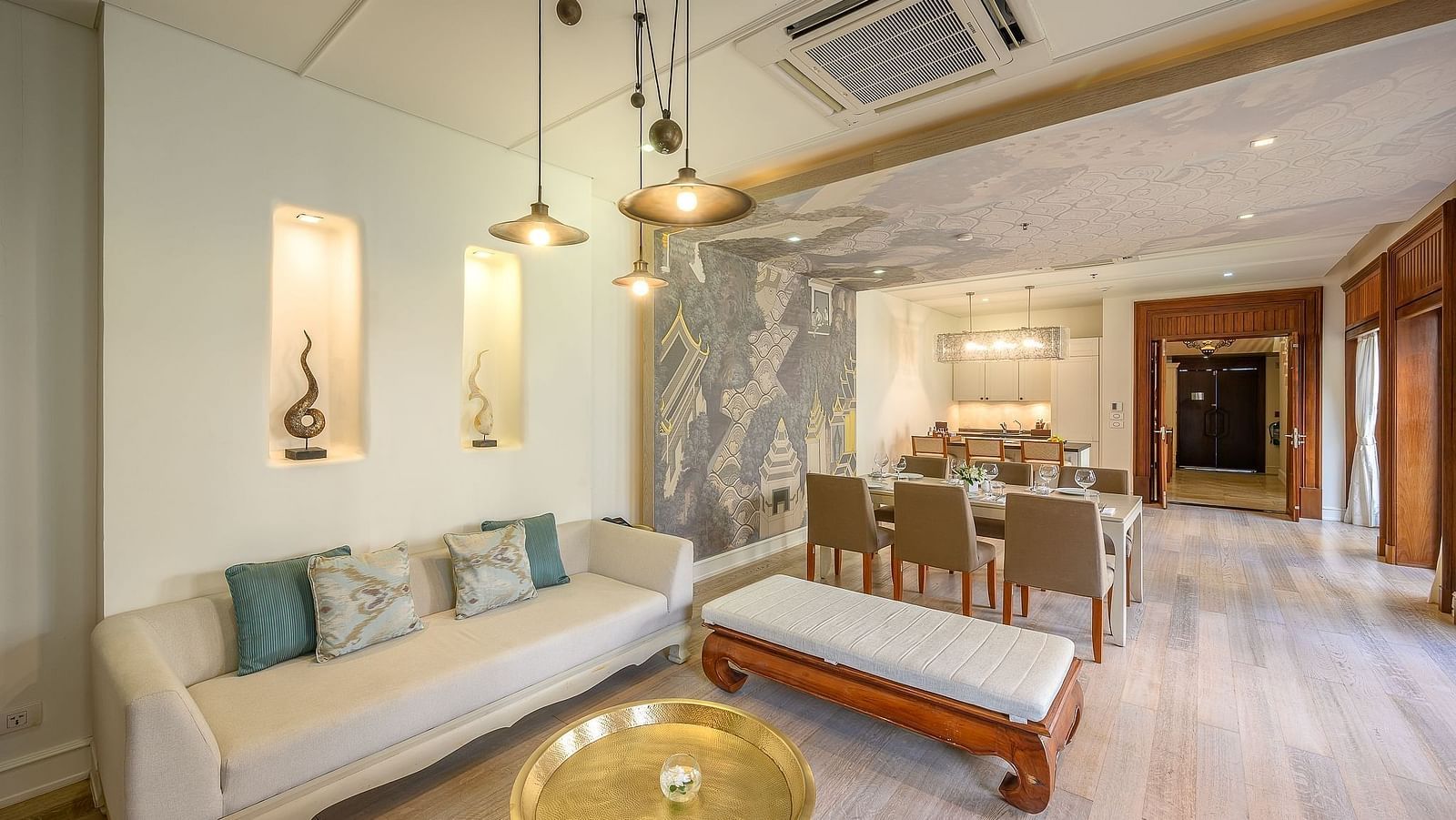 Stylish lounge area with sofa, bench, golden table and open dining area - Maikhao Dream Villa Resort & Spa, Phuket