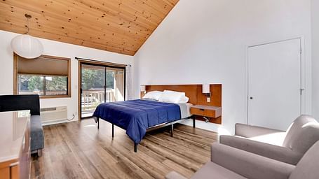 A view of a room at Amador Hotel with a double bed and sofa seating.