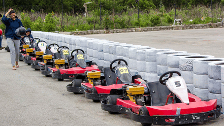 A line of red go-karts sits parked along a tyre barrier - District Gravity Adventure Park, Hyderabad