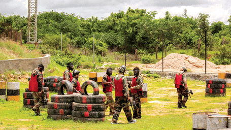 A group of players prepares for an outdoor paintball battle on a field - District Gravity Adventure Park, Hyderabad