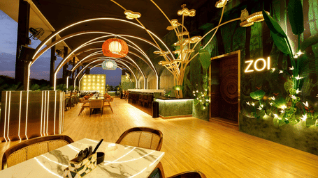 Elegant rooftop dining area at Zoi, Jenneys Residency, featuring ambient lighting and stylish decor for a fine dining experience