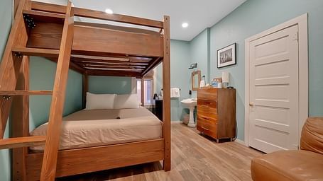 A view of a room at The Groveland Hotel with bunk beds.