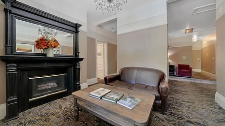 Living room area of a suite at The Groveland Hotel with sofa seating and a coffee table.