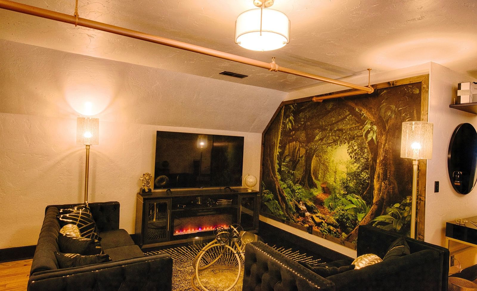 a welcoming image of the common seating area along with a flat screen television and an electric fireplace - Historic Tapoco Lodge