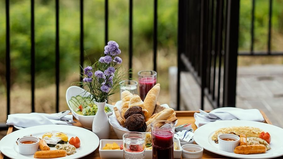 Breakfast spread on a balcony table with a view