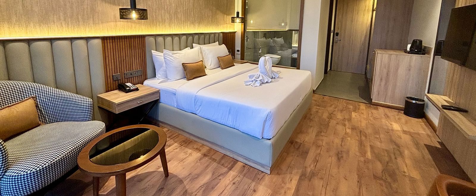 Modern bedroom with twin beds, wooden flooring, and cosy interior décor – ARNISA Boutique Hotel