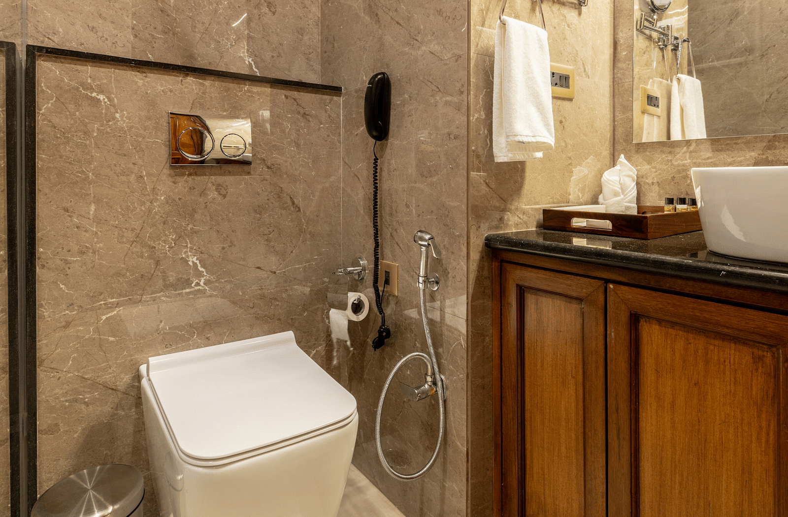 A washroom with the shower area, a toilet seat, and other toiletries - Brij Castle, Jaipur