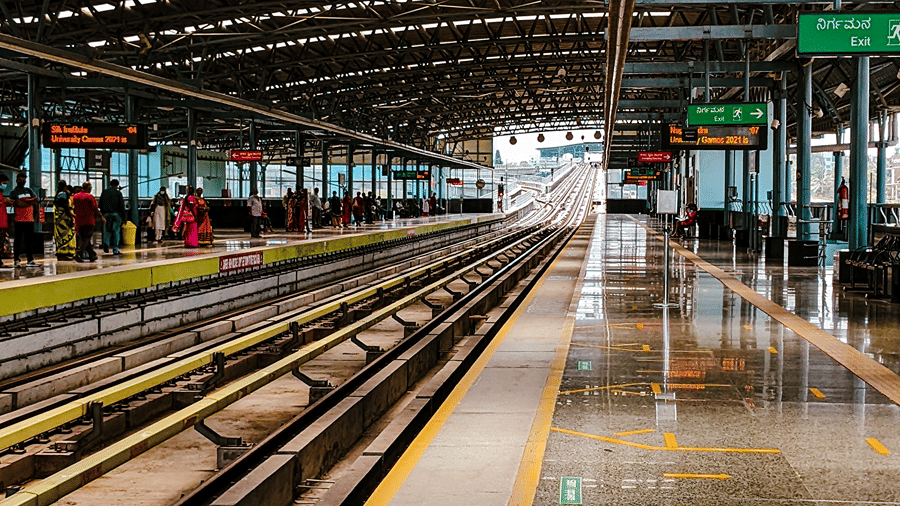 Railway platform featuring tracks and overhead signage.