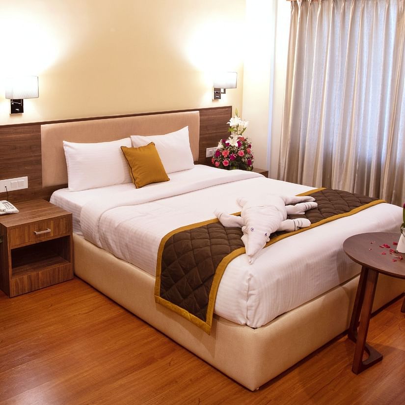 room with king size bed and wooden furnishings