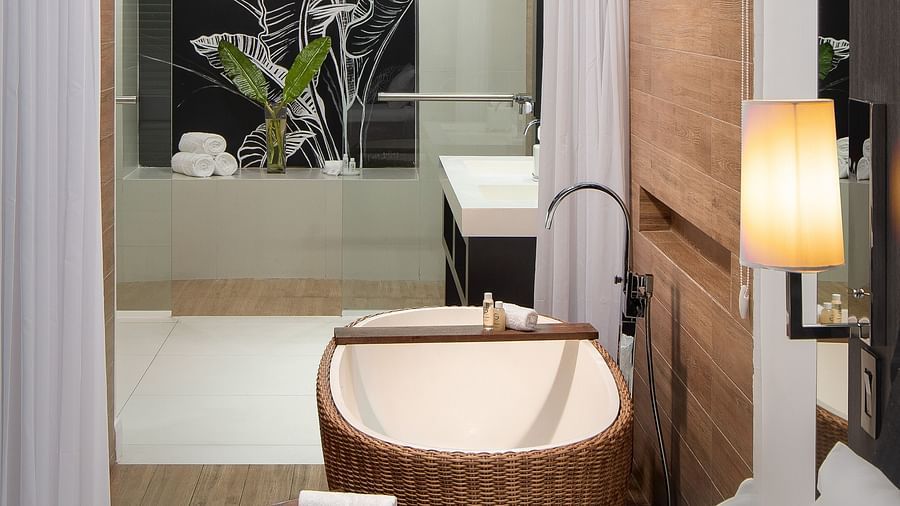 A modern bathroom observed from the ambiently lit room - S Hotel Montego Bay, Jamaica