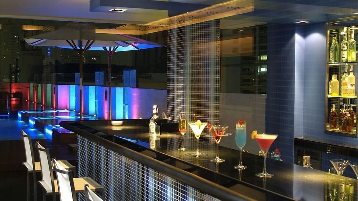 An overview of the bar counter inside Flava Lite Rooftop Pool Bar Cafe - Night Hotel Bangkok.